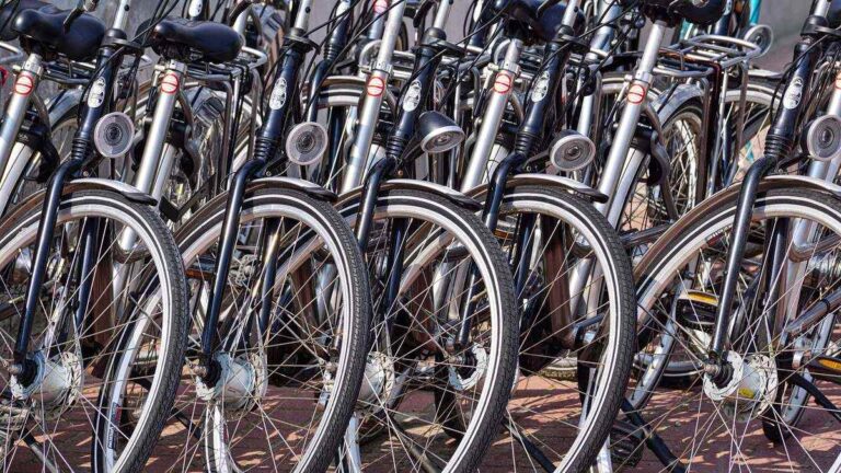Rangée de vélos d'occasion alignés contre un mur